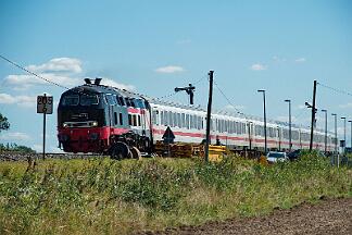 2025-08-18-053 Emmelsbüll Lehnshallig 218 497 mit IC 2214 nach Westerland.